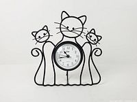front view showing three-cat wire frame and clock face