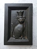 Front view showing full relief of crowned cat and rectangular frame