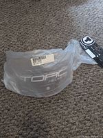 Shield inside original plastic bag with barcode label
