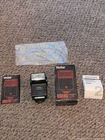 Group shot showing flash unit, box, manuals and plastic sleeve
