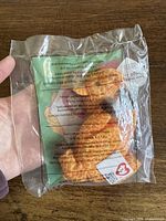 Front view of sealed package showing Twigs giraffe inside