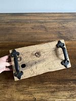 Top view of tray showing wood grain, hole, and cast iron handles