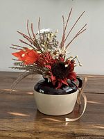 Front view of crock with faux arrangement