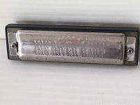 Front side of the harmonica showing 'Big River Harp' and numbering from 1 to 10 with star details.