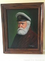 Framed oil painting showing elderly man with white beard and captain's hat, signed by artist.