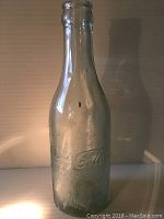 Front full view of the antique Coca-Cola bottle showing the shape and overall condition.