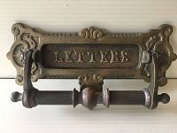 Front view of antique brass door knocker with mail slot featuring the word 'LETTERS'