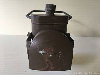 Front view showing flashlight with protective cover and rust spots