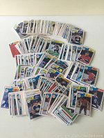 Overview of scattered vintage hockey cards from 1983-84 season with many teams and players visible.