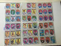 Top-down photo showing 44 hockey cards arranged in rows, identifiable by player portraits, colorful borders, and team names.