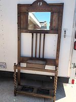 Front view of entire oak hall tree showing mirror, hooks, slatted back, barley twist legs, umbrella stand