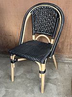 Front view of bent bamboo chair showing seat and back weave