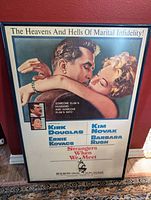 Frontal view of framed 1960 Strangers When We Meet poster showing artwork, stars, tagline
