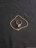 Ring and chain displayed on dark cloth