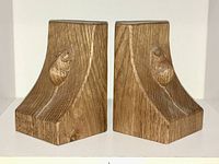Front view of the pair of oak bookends showing both carved mice and overall shape