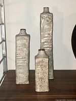 Front view of all three graduated vases on wooden surface