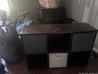 Front view of six-cube storage shelf with bins inserted