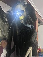 Close-up of Grim Reaper skull with lit eye and gauze shroud