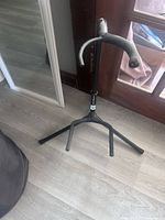 Black metal tripod guitar stand upright