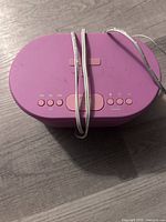 Top view showing pink i-box Dawn unit with control buttons and attached power cord
