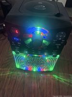 Karaoke machine powered on showing LED lights and controls