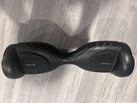 Top view of black Tomoloo hoverboard showing footpads and overall body