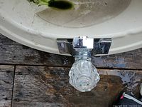 Top view showing faucet, acrylic knob and chipped rim