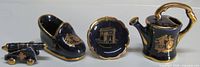 Front view of all four cobalt blue gilt porcelain miniatures
