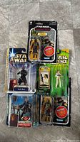 All four carded figures laid out on floor