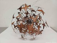 Front angled view of spherical bird sculpture