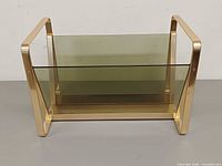 front view of brass and glass magazine rack