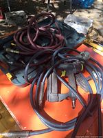 Assorted nailers and air hoses on top of carrying case