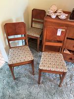 Four side chairs visible with floral seats on carpet