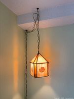 Lamp hanging from ceiling showing overall appearance and chain length