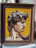 Full view of framed needlepoint artwork