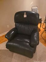 Front view of blue leather recliner upright