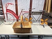 Front view of both decorative bicycles and basket