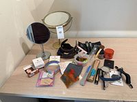 overview of lot on tabletop showing mirrors, brushes, headbands, small accessories