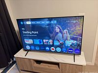 Front view of Sony Bravia TV powered on displaying Google TV home screen