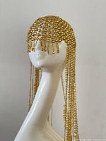 Front view of gold-tone chainmail headpiece on mannequin