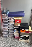 Full view of stacked plastic and cardboard shoe boxes