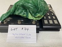 DigiTech RP360XP pedal with expression pedal and power adapter partially covered by green bag, lot card visible