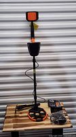 Assembled GoConova MD-4070 detector with headphones and digging tool on table