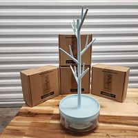 Assembled light blue jewelry tree organizer in front of four branded Half Room boxes