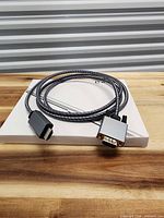 Full view of braided VGA-to-HDMI adapter cable coiled on box