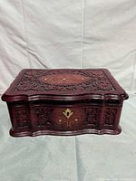 Front angled view of carved hardwood jewelry box