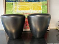 Front view of both matte black vases
