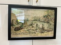 Framed watercolour landscape hung on wall