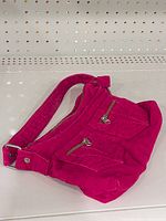 Front view showing overall shape, strap, front zipper pockets