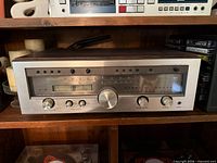 Front view of Luxman R-1120 receiver in shelf